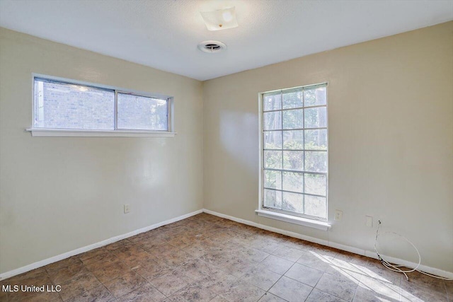 338 Lake Of Pines Dr, Jackson, MS 39206 - spare room featuring baseboards, a wealth of natural light, tile patterned floors, and visible vents