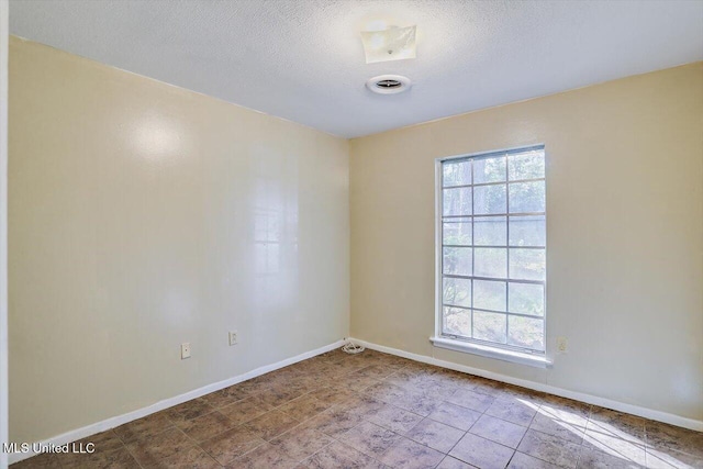 spare room featuring a textured ceiling