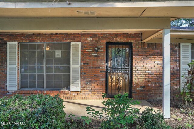 338 Lake Of Pines Dr, Jackson, MS 39206 - view of exterior entry featuring brick siding