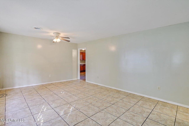 unfurnished room with light tile patterned flooring and ceiling fan