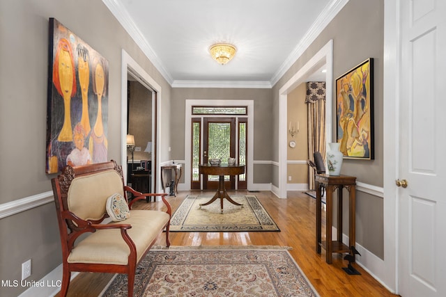 interior space with ornamental molding and light hardwood / wood-style flooring