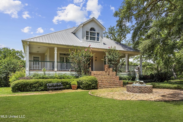 view of front of home with covered porch and a front lawn