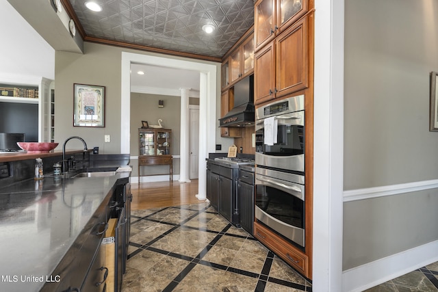 kitchen with ornamental molding, sink, and appliances with stainless steel finishes