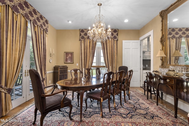 dining room featuring light hardwood / wood-style floors, a notable chandelier, and a wealth of natural light