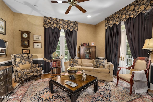 living room featuring ceiling fan, light hardwood / wood-style flooring, and plenty of natural light