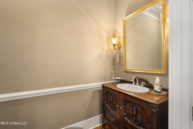 bathroom featuring vanity and ornamental molding