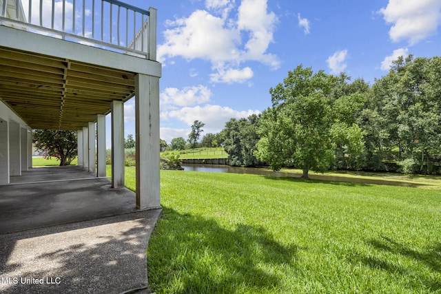 view of yard featuring a patio area and a water view