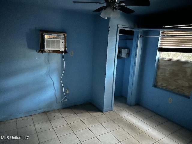 unfurnished bedroom featuring a wall unit AC, a closet, and ceiling fan