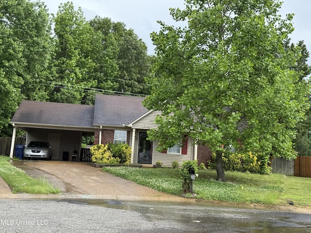 view of front of home featuring driveway, a carport, brick siding, and roof with shingles