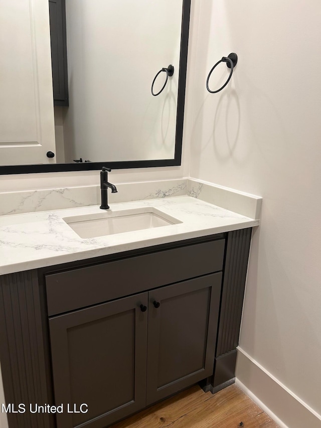 bathroom with vanity and hardwood / wood-style floors