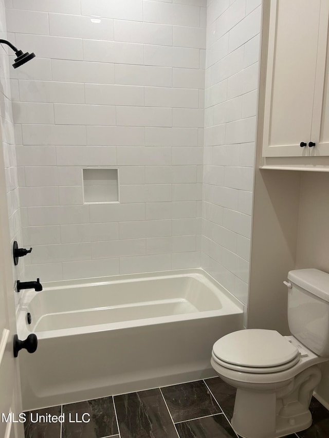 bathroom featuring toilet and tiled shower / bath combo