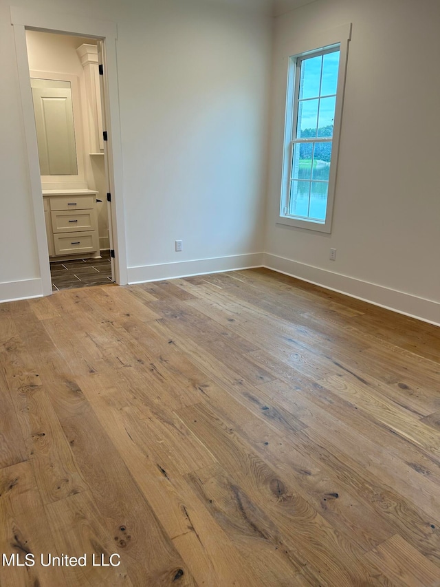 empty room with light hardwood / wood-style flooring