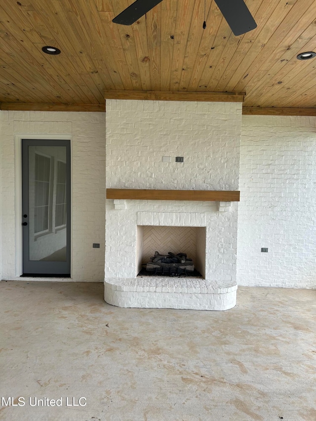 exterior details with wood ceiling, an outdoor brick fireplace, and ceiling fan