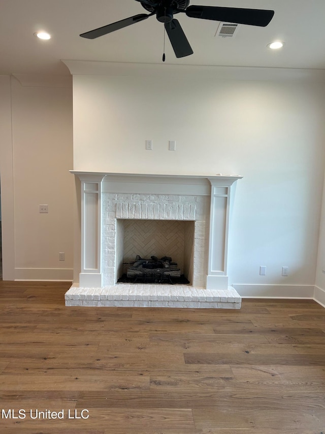 room details featuring hardwood / wood-style floors, a brick fireplace, and ceiling fan