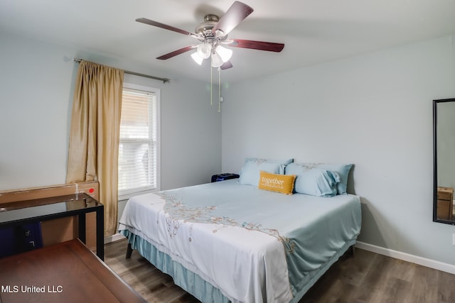 bedroom featuring baseboards, wood finished floors, and a ceiling fan