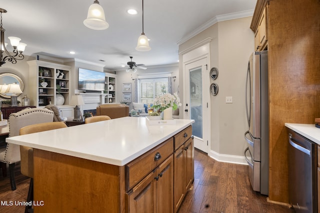 23 Callaway Ct, Hattiesburg, MS 39402 - kitchen featuring stainless steel appliances, brown cabinetry, a ceiling fan, dark wood-type flooring, and a breakfast bar area