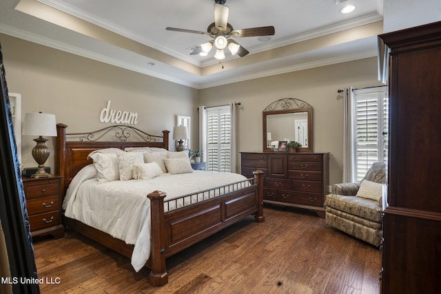 23 Callaway Ct, Hattiesburg, MS 39402 - bedroom featuring a raised ceiling, multiple windows, dark wood-style flooring, ornamental molding, and a ceiling fan