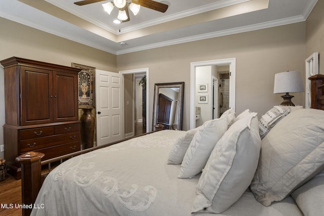 23 Callaway Ct, Hattiesburg, MS 39402 - bedroom featuring a raised ceiling, crown molding, wood finished floors, a ceiling fan, and ensuite bathroom