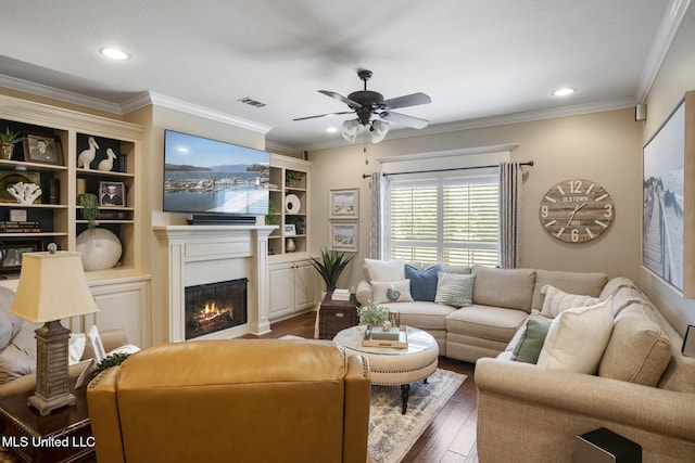 23 Callaway Ct, Hattiesburg, MS 39402 - living room with dark wood finished floors, ceiling fan, a glass covered fireplace, ornamental molding, and recessed lighting