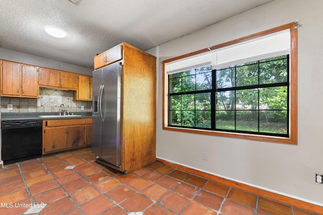 20 Yorkshire Pkwy, Gulfport, MS 39503 - kitchen with black dishwasher, stainless steel fridge, a sink, backsplash, and baseboards