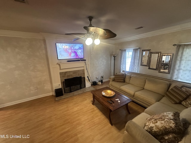 713 Hawthorn Green Dr, Ridgeland, MS 39157 - living room with ceiling fan, light wood finished floors, ornamental molding, a fireplace, and baseboards