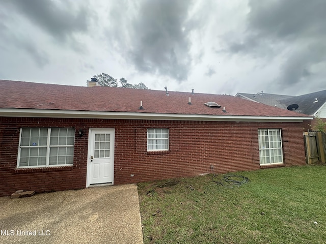 713 Hawthorn Green Dr, Ridgeland, MS 39157 - rear view of property featuring a yard, brick siding, and a chimney