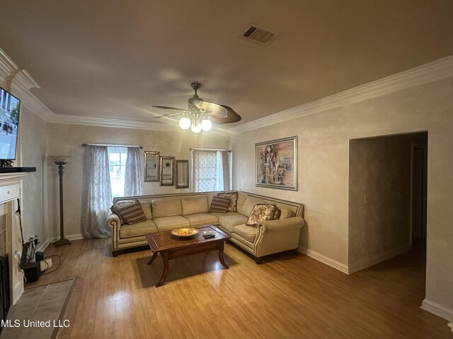 713 Hawthorn Green Dr, Ridgeland, MS 39157 - living room featuring ceiling fan, wood finished floors, ornamental molding, baseboards, and a tile fireplace