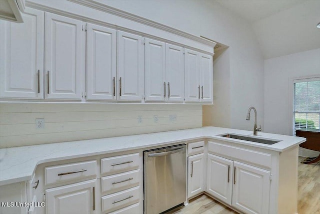 kitchen featuring white cabinetry, stainless steel dishwasher, and sink