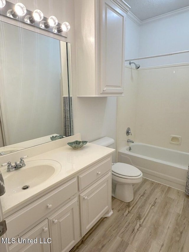 full bathroom featuring wood-type flooring, vanity, a textured ceiling, toilet, and shower / bathtub combination with curtain