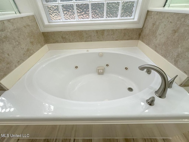 bathroom featuring tiled bath