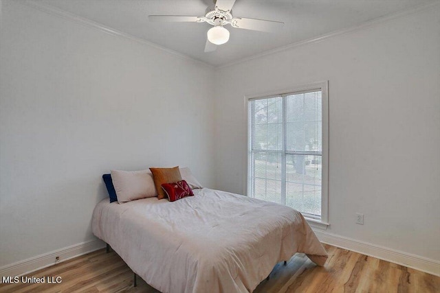 bedroom featuring light wood-type flooring, multiple windows, ceiling fan, and ornamental molding