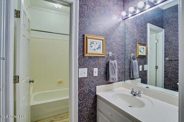 bathroom with hardwood / wood-style floors, vanity, and crown molding