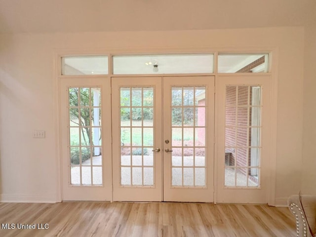 doorway featuring a wealth of natural light, light hardwood / wood-style flooring, and french doors