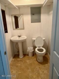 half bathroom with electric panel and toilet