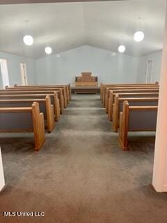 interior space with vaulted ceiling and carpet