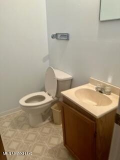 half bathroom with toilet and vanity