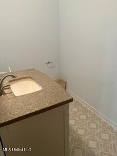 bathroom with baseboards and vanity