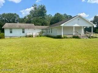 rear view of house with a yard