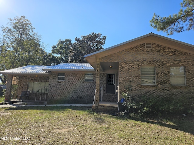 back of house with a lawn