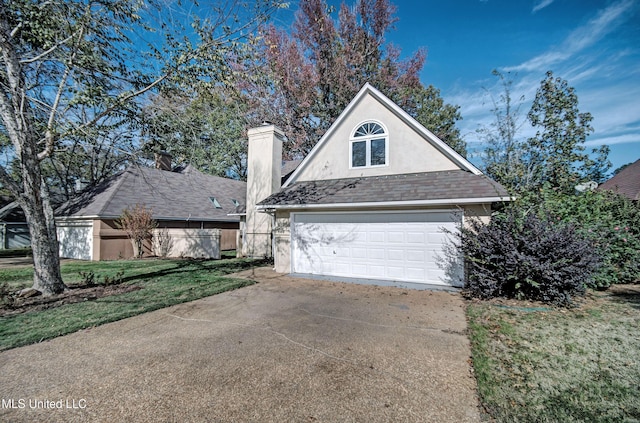 view of side of property with a yard and a garage