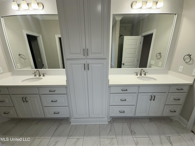 full bathroom with vanity, ornamental molding, and marble finish floor