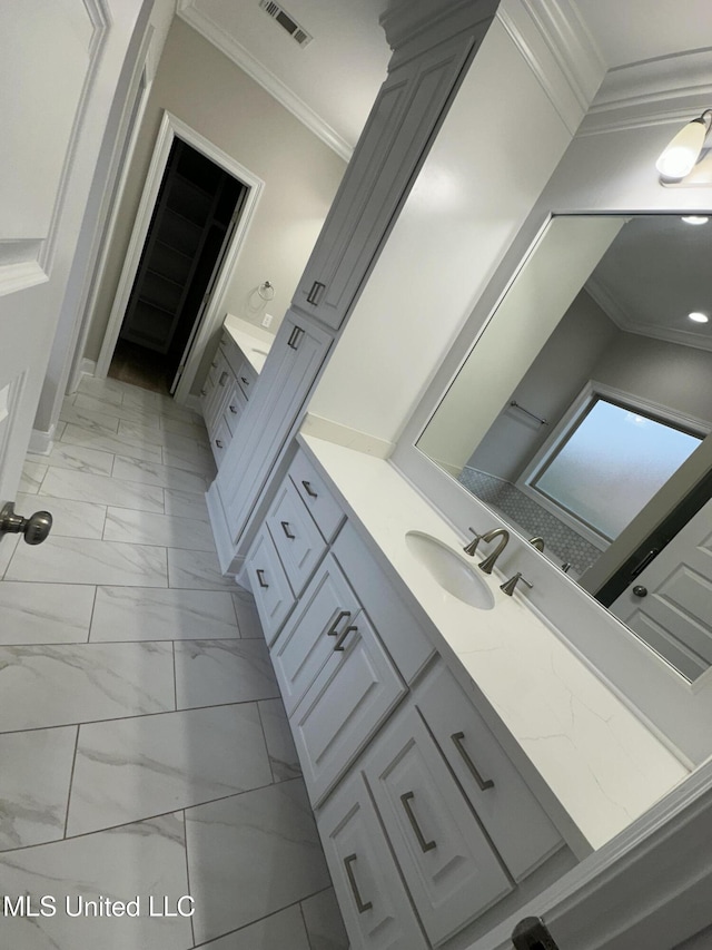 bathroom with visible vents, ornamental molding, marble finish floor, and vanity