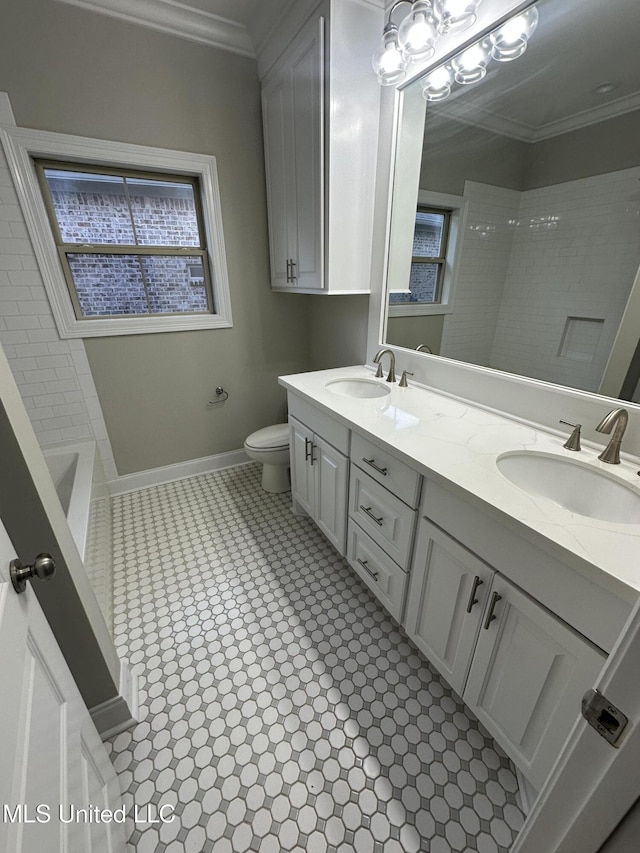 full bath with a sink, ornamental molding, and toilet