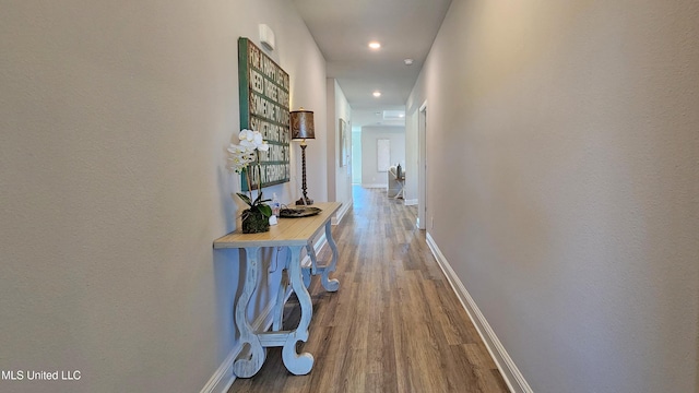 hallway with hardwood / wood-style floors