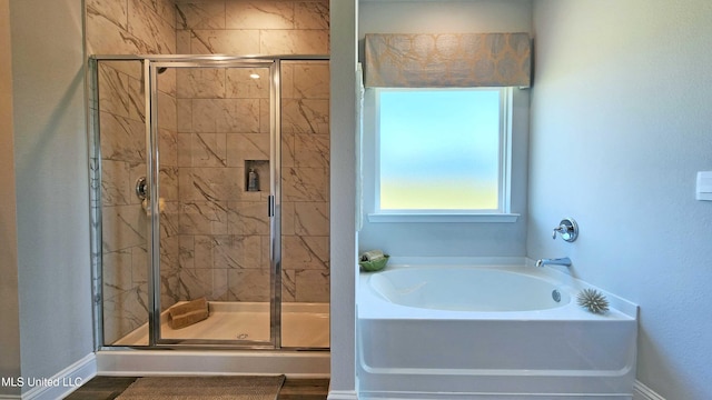 bathroom featuring shower with separate bathtub