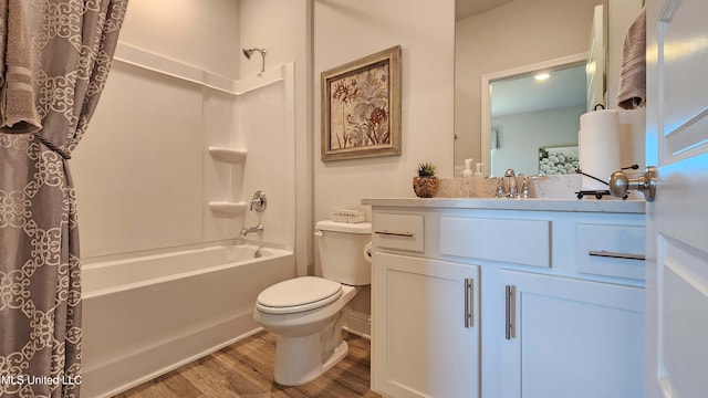 full bathroom featuring hardwood / wood-style floors, vanity, toilet, and shower / bath combo with shower curtain