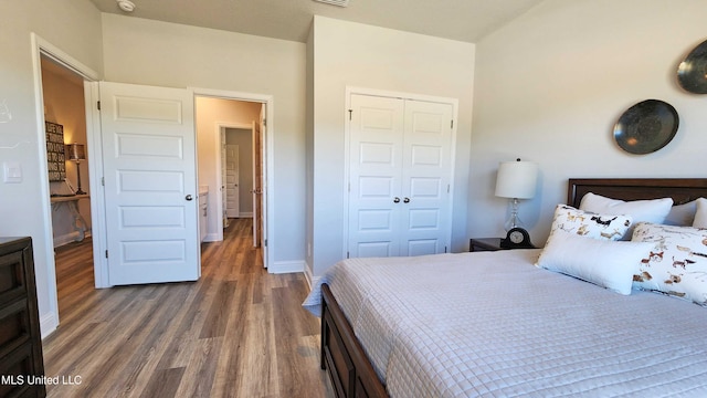 bedroom featuring dark hardwood / wood-style flooring and a closet