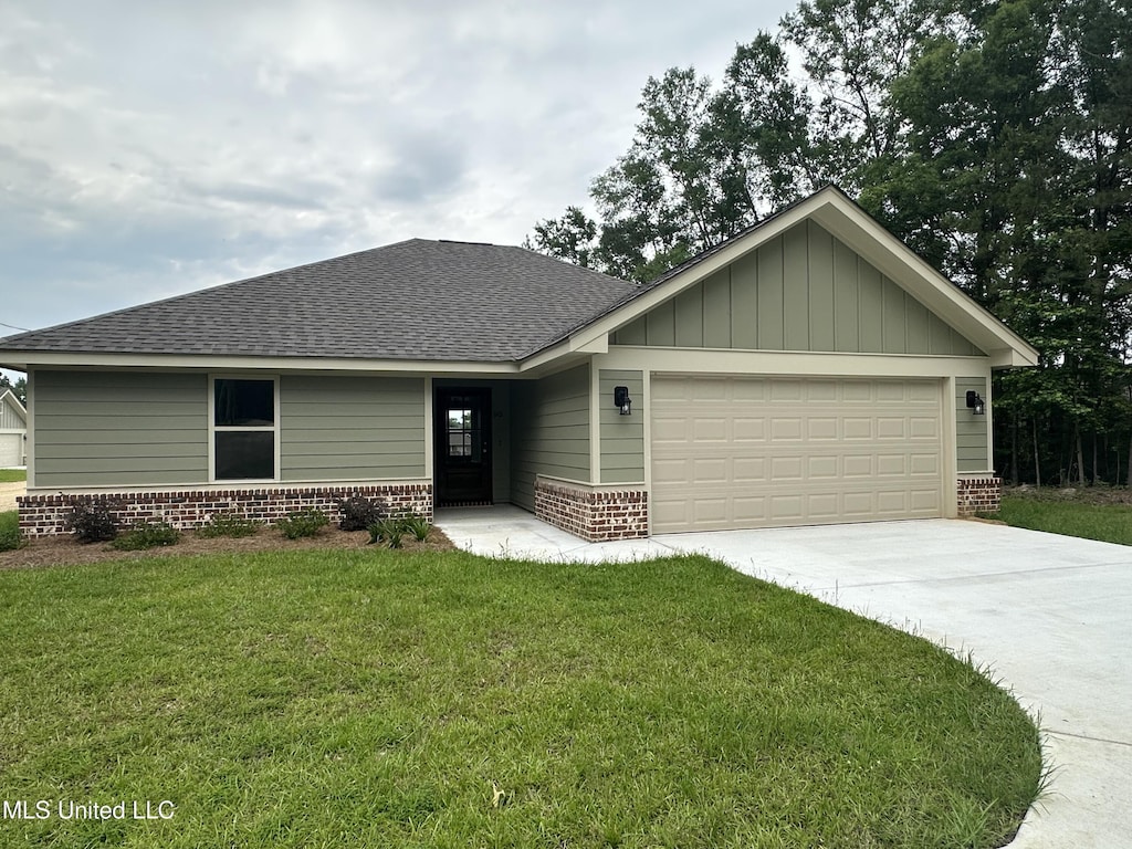 90 Todd Rd, Sumrall, MS 39482 - view of front of property featuring a garage, a shingled roof, a front lawn, brick siding, and driveway