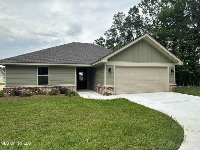 90 Todd Rd, Sumrall, MS 39482 - view of front of property featuring a garage, a shingled roof, a front lawn, brick siding, and driveway