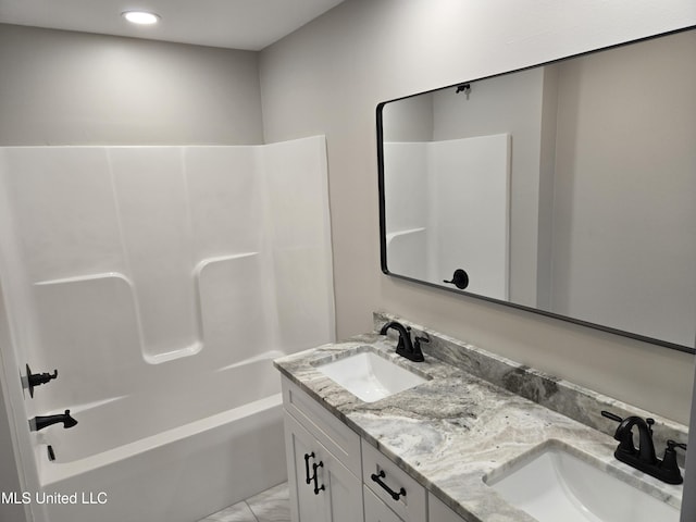 bathroom with recessed lighting, double vanity, and shower / washtub combination